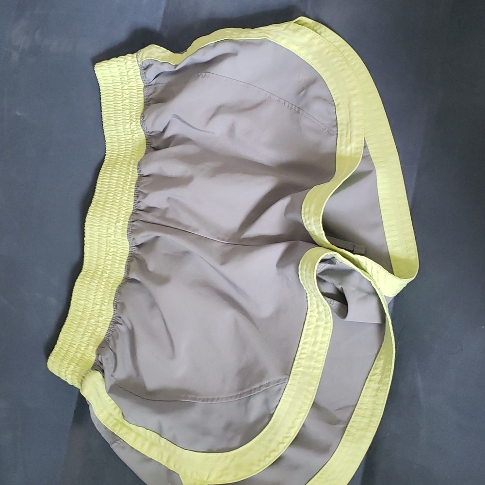 Size small Grey althetic shorts with yellow accents. No outside damage